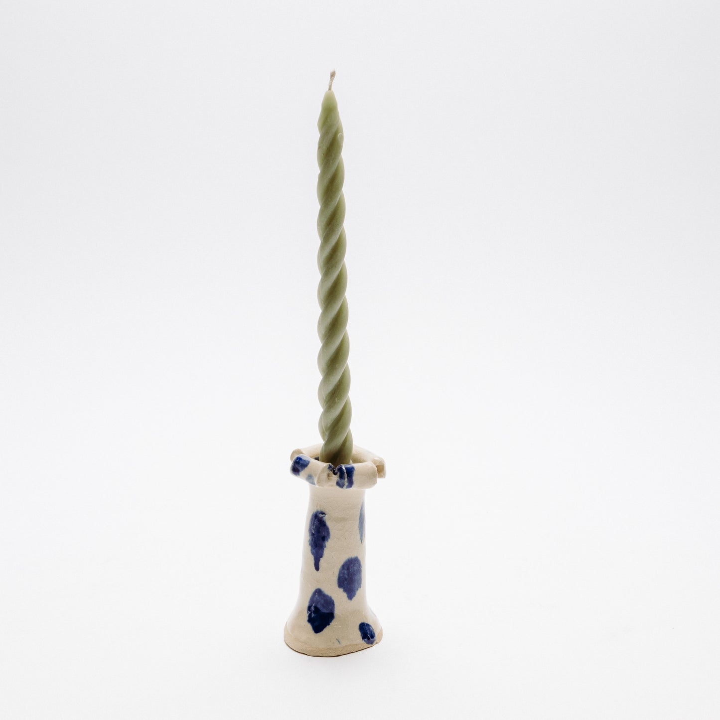 white candle stick with blue drip