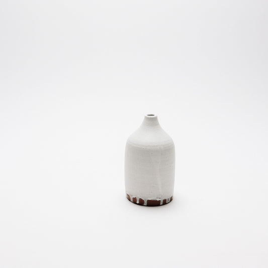 white on brown drip bud vase